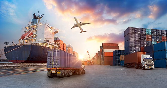 Container truck in ship port for business Logistics and transportation of Container Cargo ship and Cargo plane with working crane bridge in shipyard at sunrise, logistic import export and transport industry background
