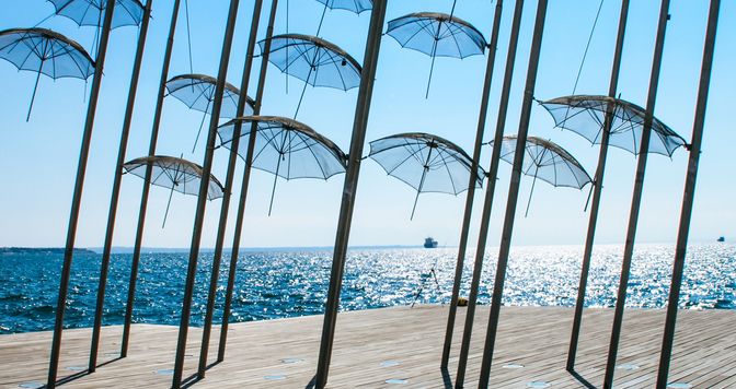 The seafront in the city of Thessaloniki, Greece. Mediterranean Sea,performance on the beach with umbrellas
